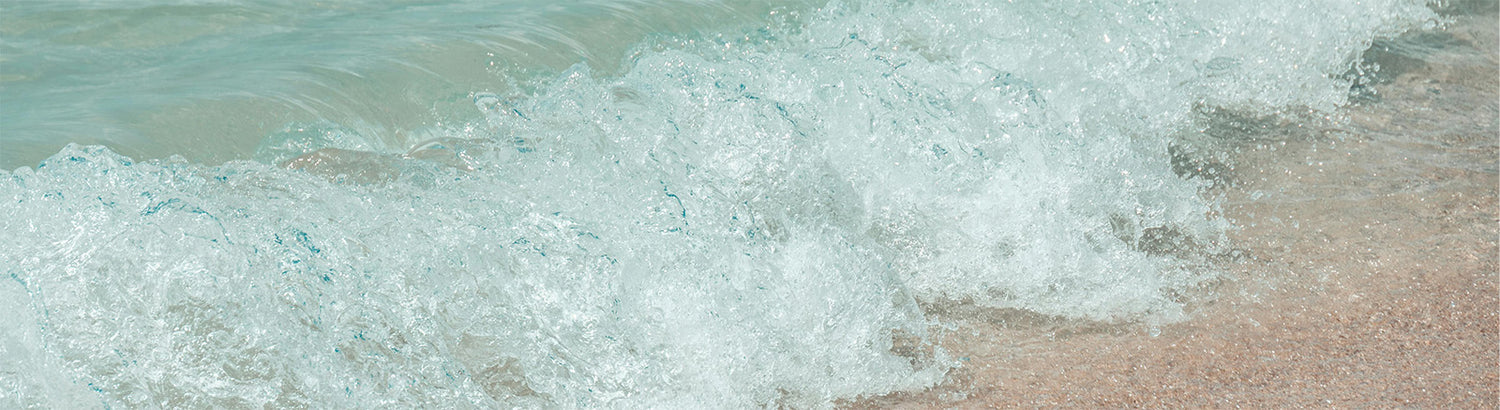 Wave crashing onto a sandy beach
